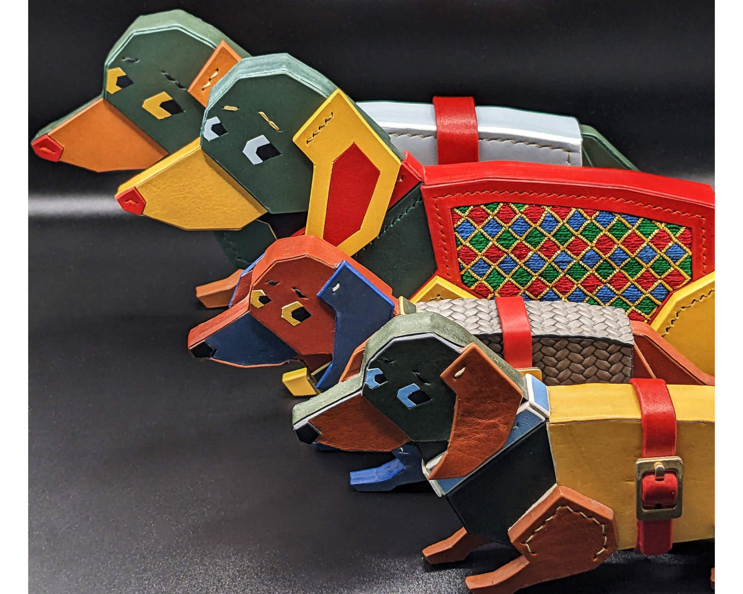 Colorful leather dog-shaped wallets arranged on a dark surface